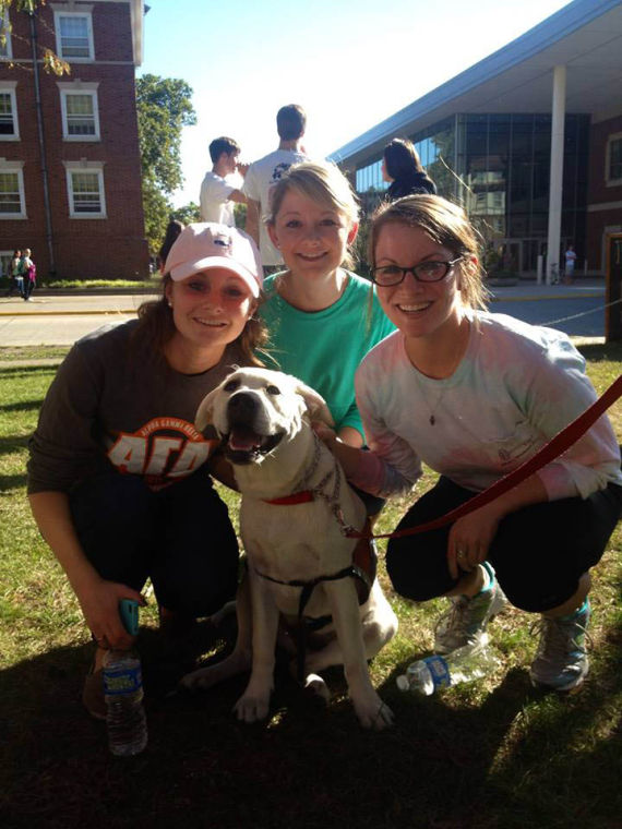 Shi-Ai members pose at their philanthropic event, “Pet-a-Pup for a Buck, which took place last semester. Students could pay a $1 to pet a dog, and all proceeds went to the Illini Service Dogs student organization.