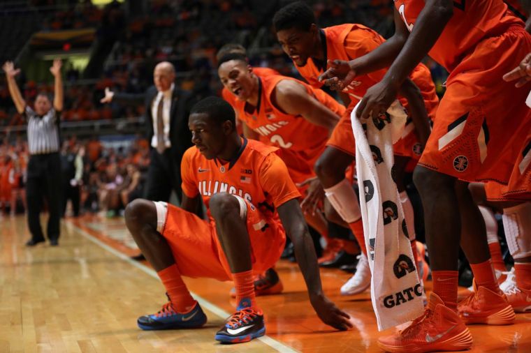 Illinois Kendrick Nunn (25) falls to ground after making a three point shot as his teammates celebrate behind him, during the game against Chicago State at State Farm Center, on Friday, Nov. 23, 2013. The Illini won 77-53.