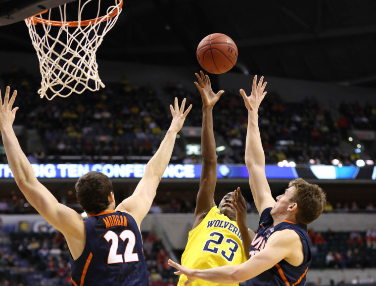 Illinois Jon Ekey (33) and Maverick Morgan (22) attempt to block Michigans Caris LeVert (23) during their quarter-final game of the Big Ten Mens Basketball Tournament at Bankers Life Fieldhouse, on Friday, Mar. 14, 2014 The Illini lost 64-63.