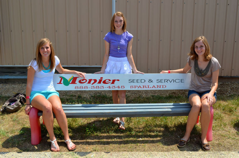 Sondra Monier (left) sits with her two sisters, Jillian (middle) and Hannah, at the Marshall-Putnam Country Fair in July 2012. Monier came from Sparland, Ill., a small-town population of 396 that she feels gives her a unique perspective at the University.