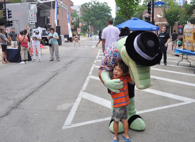 Landon Harper, five-year-old Champaign resident, hugs Louie the Alligator at the Bud Light Summer Stage event Saturday, July 26.
 