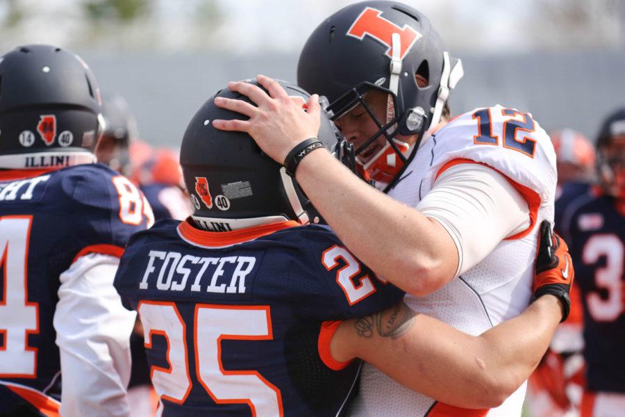 Illinois Wes Lunt (12) and Kendrick Foster (25) celebrate a touchdown during the annual Orange and Blue Spring Game at Memorial Stadium, on Saturday, April 13, 2014. The Blue team won 38-7.