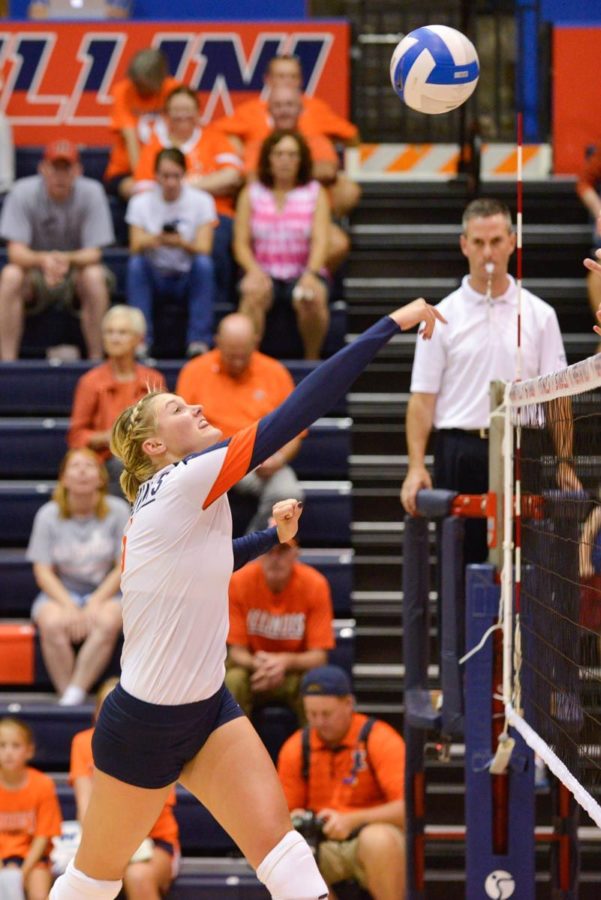 Illinois middle blocker Maddie Mayers hits the ball during the Alumni Match on Saturday, Aug. 23, 2014. The orange and blue teams tied 2-2.