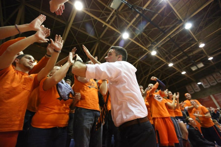 Illinois' head coach Kevin Hambly gives high fives during a match at Huff Hall. Huff Hall has has recently finished renovations to be ready for this upcoming season.