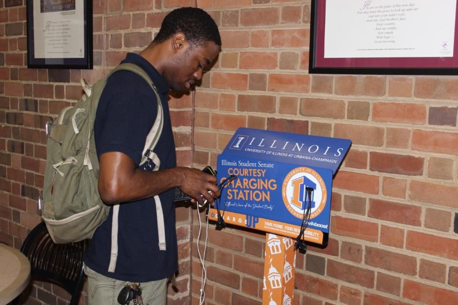 Jon Buie, senior in engineering, uses one of the new charging stations set up in the Illini Union.
