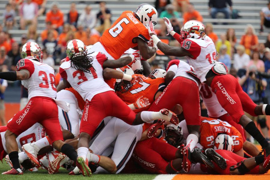 Running back Josh Ferguson puts Illinois on the board first with a touchdown in the first quarter against Western Kentucky at Memorial Stadium on Saturday. The Illini won 42-34.