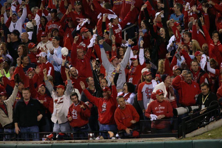 St. Louis Cardinals fans react to Matt Hollidays solo homer in the fourth inning against the Boston Red Sox during Game 5 of the World Series at Busch Stadium in St. Louis, Missouri, on Monday, October 28, 2013.