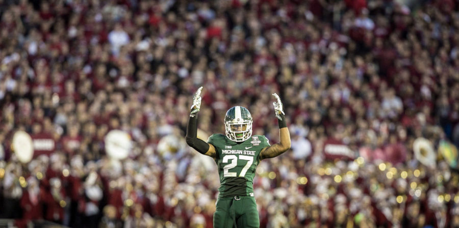 Michigan State safety Kurtis Drummond (27) urges on the crowd before a crucial stop on fourth down during the fourth quarter against Stanford in the 100th Rose Bowl in Pasadena, Calif., Jan. 1, 2014. Michigan State won, 34-24. (Jarrad Henderson/Detroit Free Press/MCT)