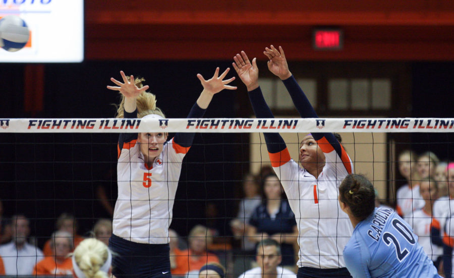 Illinois Anna Dorn (5) and Morganne Criswell (1) attempt to block a hit from North Carolinas Taylor Treacy (20) during the North Carolina volleyball game at Huff Hall on Saturday, August 30, 2014. The Illini won 3-0.