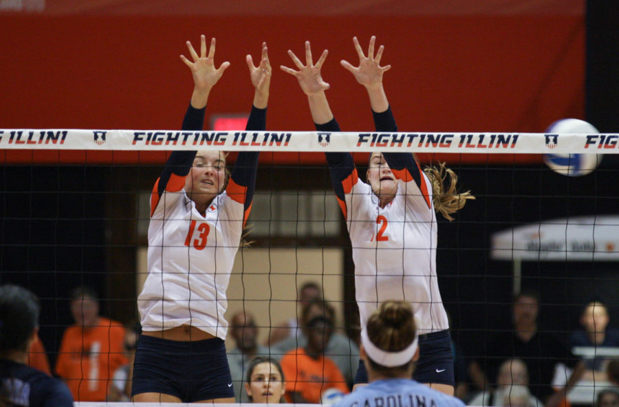 Illinois Ali Stark (13) and Katie Stadick (12) attempt to block a hit during the North Carolina volleyball game at Huff Hall on August 30. 
