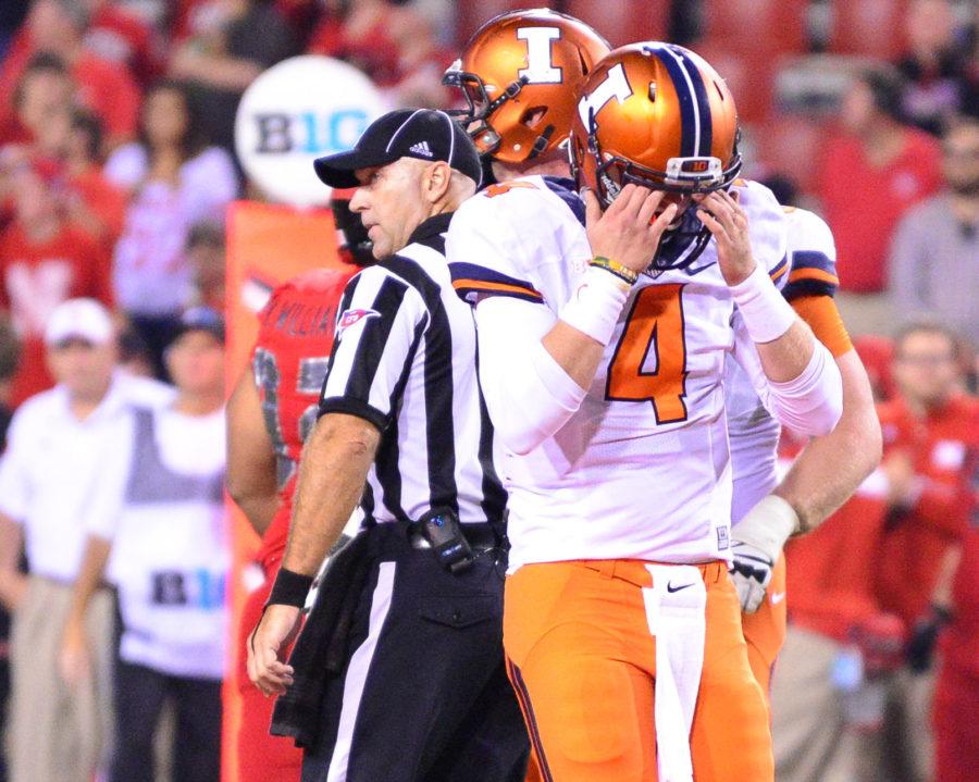 Illinois’ Reilly O’Toole holds his helmet in disappointment after losing to Nebraska, 45-14.