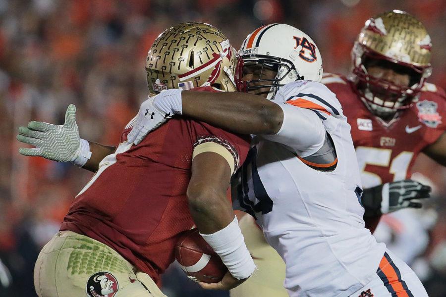 Auburn Tigers defensive end Dee Ford sacks Florida State Seminoles quarterback Jameis Winston in the first half of the BCS National Championship game at the Rose Bowl in Pasadena, Calif., on Monday, Jan. 6, 2014.