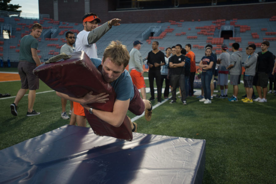 David Grömling, senior in engineering and exchange student, performs a tackling drill. University students from all around the world gathered at Memorial Stadium on Wednesday to learn about American football, which was taught by Coach Tim Beckman and the football coaching staff.
