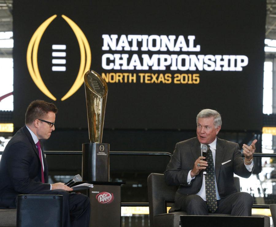 Chris Cotter, left, of ESPN, talks with Mack Brown at the 75 Day Out Luncheon to commemorate the inaugural College Football Playoff National Championship at AT&T Stadium in Arlington, Texas on Wednesday.