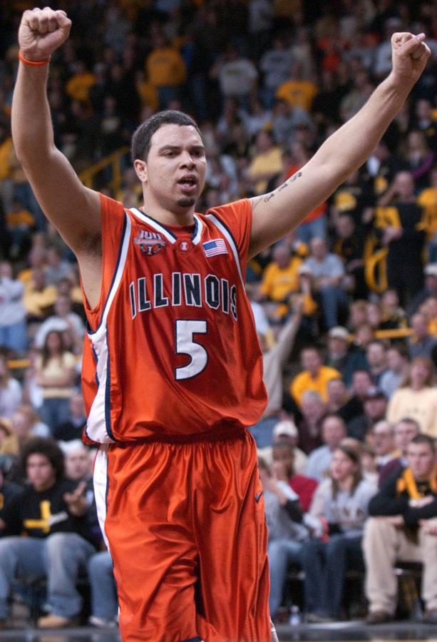 Illinois Deron Williams raises his arms to celebrate points scored by teammate Dee Brown during the second half of the game at the University of Iowa on Feb. 11, 2005.
