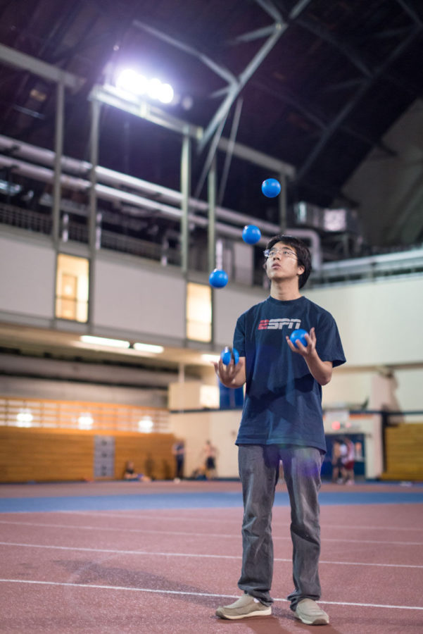 Raymond Li, senior in Engineering, practices juggling on the Armorys indoor track on October 6th, 2014.