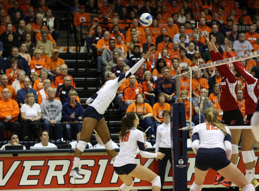 Illinois Morganne Criswell tips the ball over the net during the game against Wisconsin on Saturday.