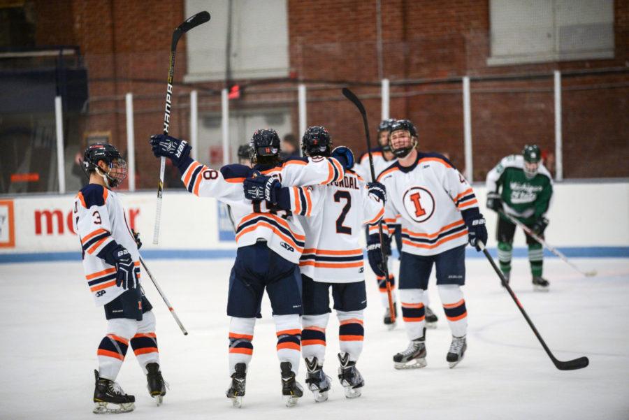Members of the Illini hockey team celebrate during the game against Michigan State on Fri. Sept. 26, 2014. The Illini won 4-2.