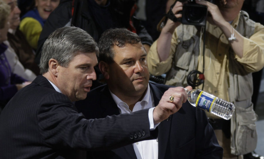 Michigan athletic director Dave Brandon, left, shows football coach, Brady Hoke, to his seat for the Michigan mens basketball game against Ohio State on January 12, 2011.