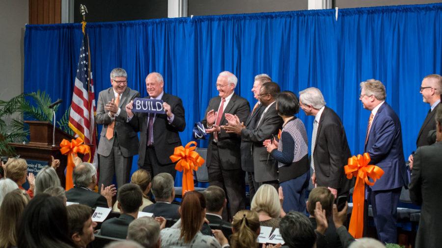 Illinois Governor Pat Quinn proudly displays his cut of the ribbon in the Grainger Auditorium at the new ECE building on Oct. 10, 2014.