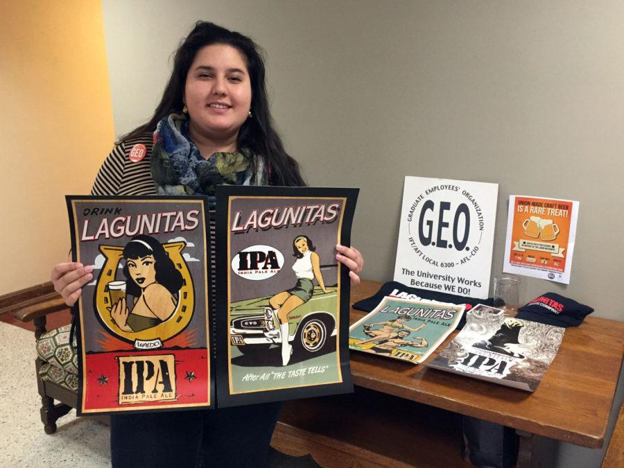 Sameerah Ahmad, one of Graduate Employees’ Organization’s two union organizers, stands with promotional materials for the GEO’s first Craft Beer Night planned for Saturday from 7 to 10 p.m. at the Indi Go Artist Co-op and Gallery.