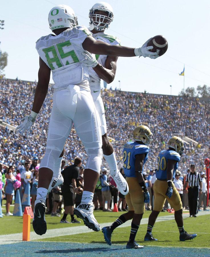 Oregon tight end Pharoah Brown (85) celebrates a 31-yard touchdown reception with teammate Dwayne Stanford in the second quarter against UCLA at the 2014 Rose Bowl.