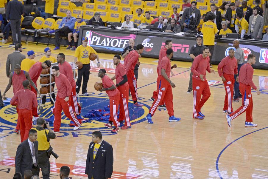 Los Angeles Clippers remove their warm up jackets in sign of protest over the alleged racist remarks made by their owner, Donald Sterling, before playing the Golden State Warriors in Game 4 of the NBA Western Conference quarterfinals at Oracle Arena in Oakland, Calif.