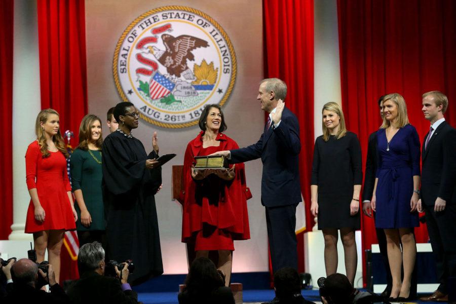 Bruce Rauner with his wife, Diana, by his side is sworn in as governor of the State of Illinois on Monday, Jan. 12, 2015 at the Prairie Capital Convention Center in Springfield, Ill. Rauners 6 children and son-in-law are on the stage with them.