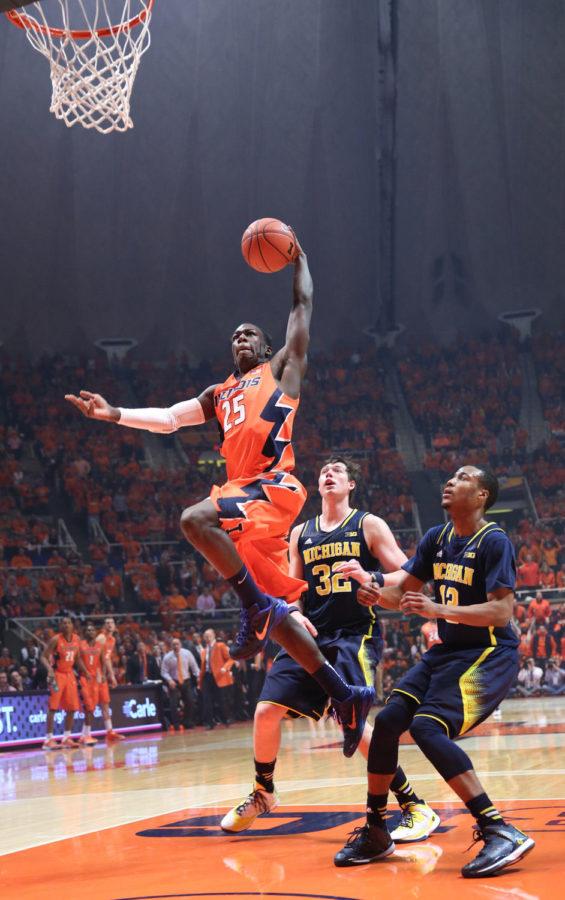 Illinois Kendrick Nunn (25) rises while attempting to finish a fast-break with a dunk during the game against Michigan at State Farm Center, on Feb. 12, 2014. The Illini won 64-52.