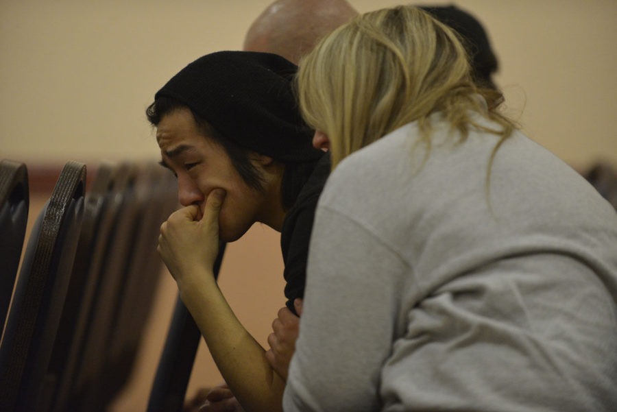 Isaac Bahn, sophomore in LAS and Vicente Mundos fraternity brother, tears up during the vigil held for Mundo at the Illini Union on Sunday, February 1, 2015.