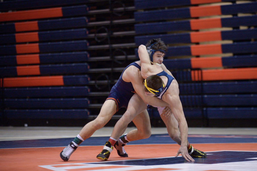 Illinois’ Isaiah Martinez attempts to press Kent State’s Ian Miller to the ground during the match at Huff Hall on Sunday. The Illini won 38-0.