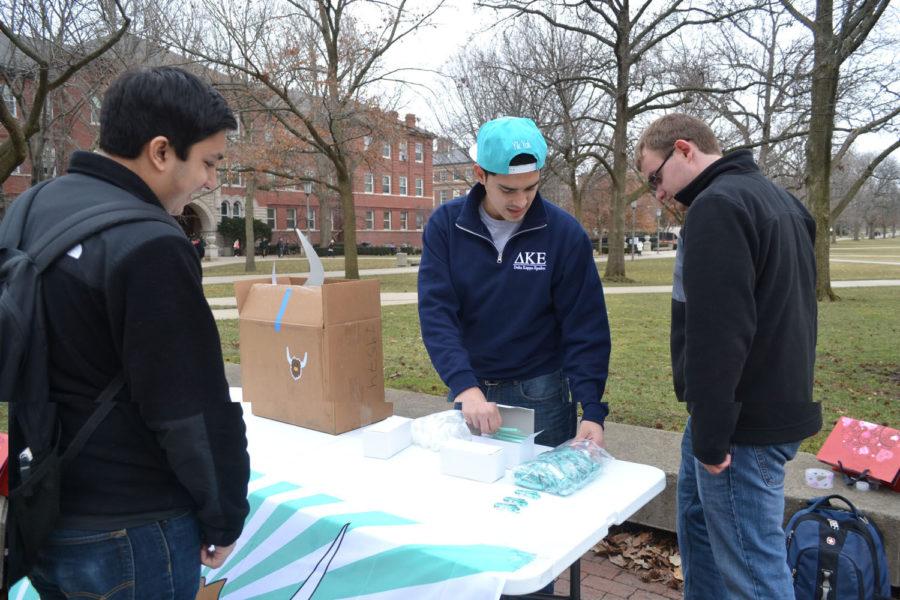 Gabriel Gonzalez, campus representative for Yik Yak and a sophomore in the College of Media, distributes free merchandise to students on the Quad on Wednesday.