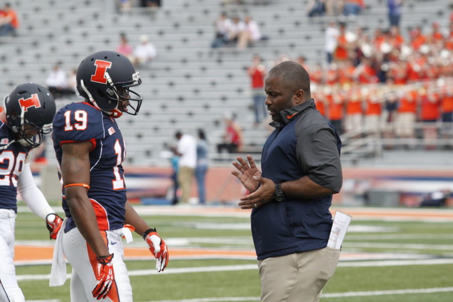 Illinois football wide receivers coach Mike Bellamy talks to Justin Hardee before Orange and Blue Spring Game at Memorial Stadium last year. The NCAA has suspended Bellamy for one game in 2015 for a breach of conduct violation.