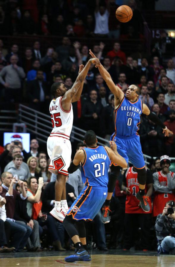 The Chicago Bulls’ E’Twaun Moore hits a game-winner against Oklahoma City’s Russell Westbrook at the United Center in Chicago on Thursday. The Bulls won, 108-105. 