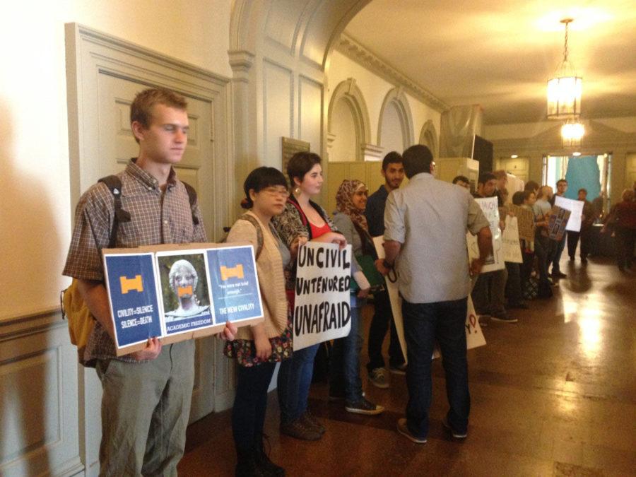 Student activists stand at the back of the Illini Union Ballroom, protesting the rejection of Salaita and censorship.