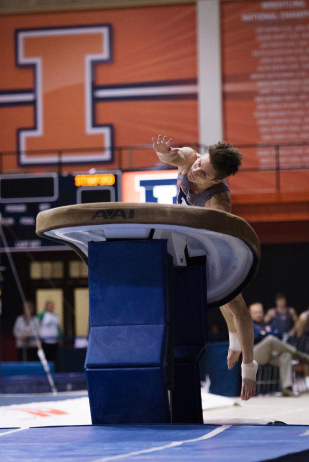 Illinois Bobby Baker jumps onto the vault during the meet against Stanford at Huff Hall on Friday, March 6.The Illini lost 21-9.