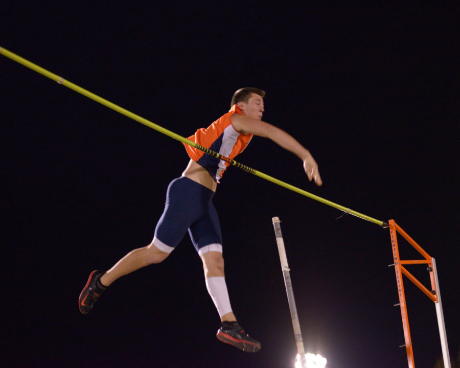 Illinois’ Mitch Mammoser releases the pole as he swings over the bar during the poll vault event at the Illinois Twilight Meet.