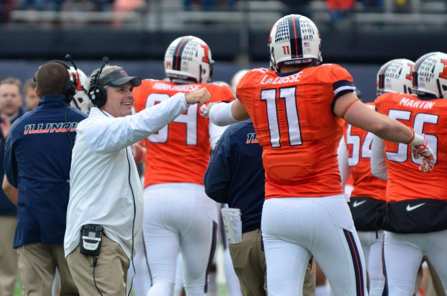Illinois head coach Tim Beckman congratulates Matt LaCosse (11) after a touchdown during the teams game against Penn State at Memorial Stadium on Nov. 22, 2014. Several former and current players tweeted out support for Beckman on Thursday.