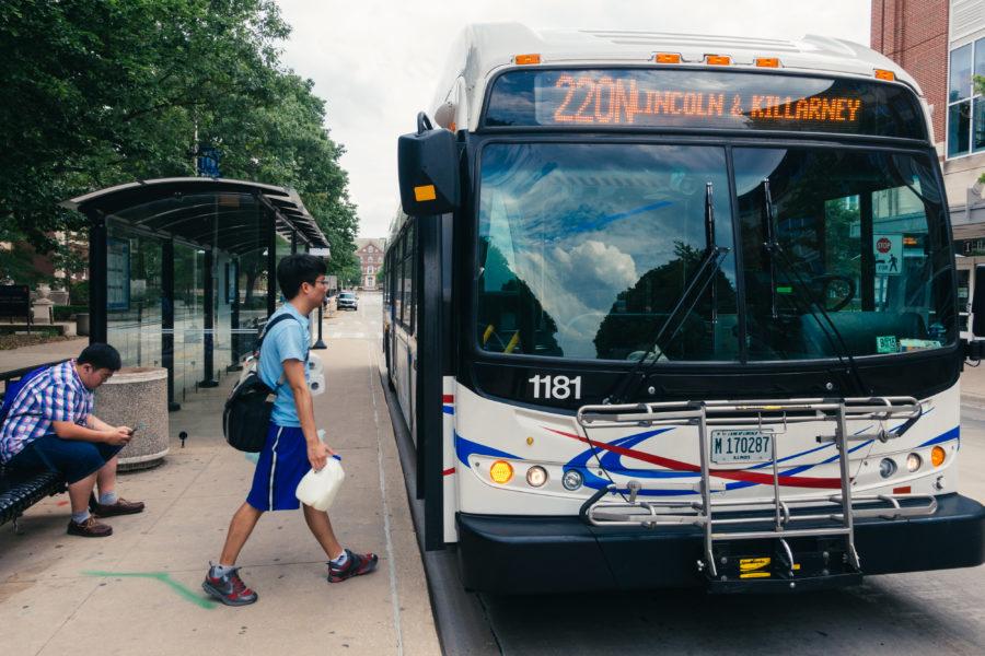 A student boards the 220N bus at the Transit Plaza.