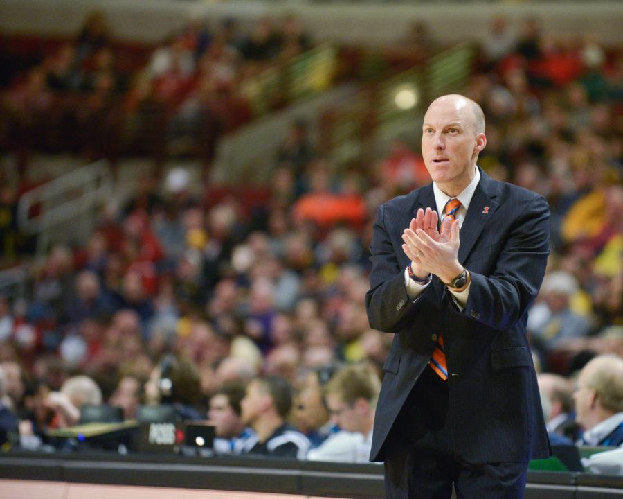 Illinois head coach John Groce claps after a Michigan turnover during the game at United Center in Chicago, Illinois during the Big Ten Tournament on Thursday, March 12, 2015. 