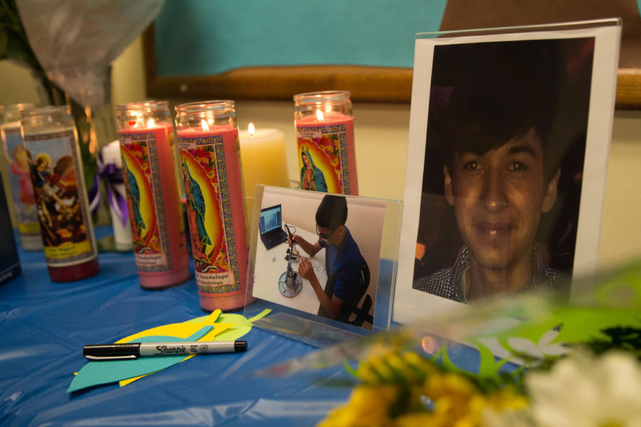 A picture of Vicente Mundo sits next to candles placed on a table during a vigil for Mundo at the La Casa Cultural Latina on Monday.