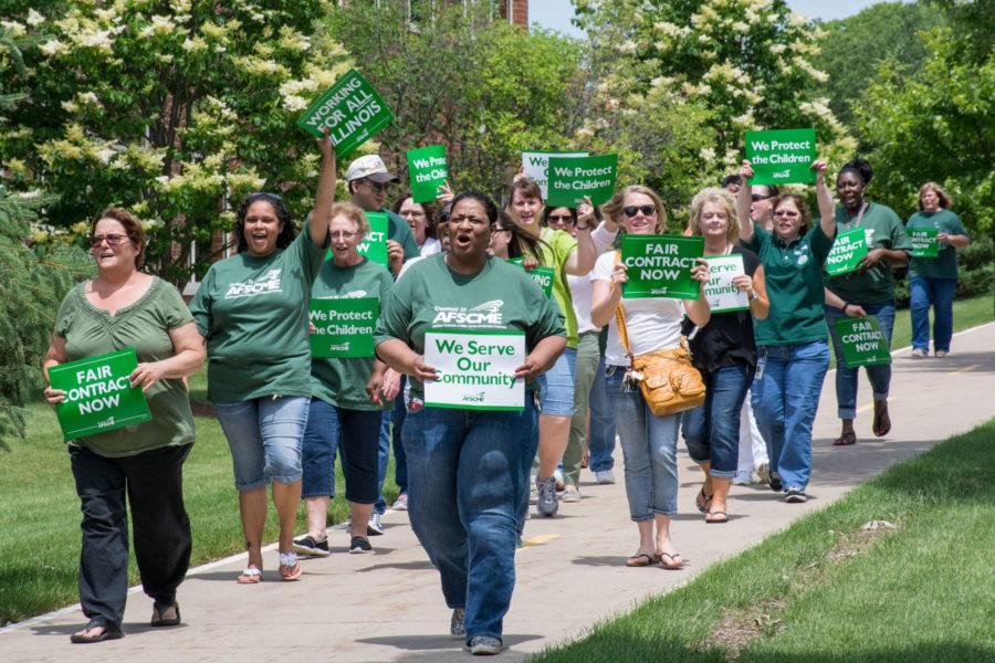 State employees rally and march in support of public services along S. First Street in Champaign on Wednesday, June 10.