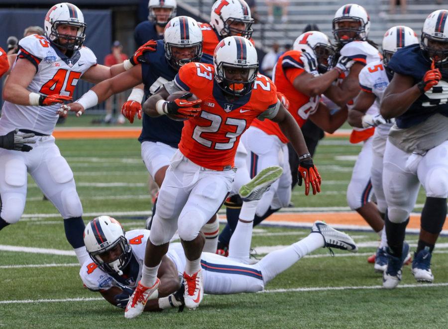 Illinois Henry Enyenihi (23) runs the ball down field during the annual football Spring Game at Memorial Stadium on Saturday, Apr. 18, 2015. The Orange won 44-41.
