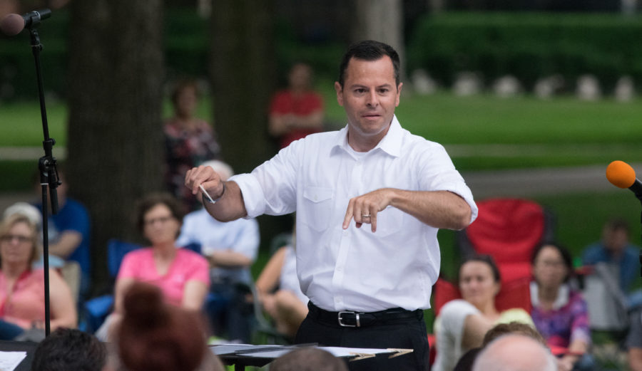 Assistant Director of Bands Barry L. Houser conducts the University Summer Band during a performance on July 16 on the Main Quad.