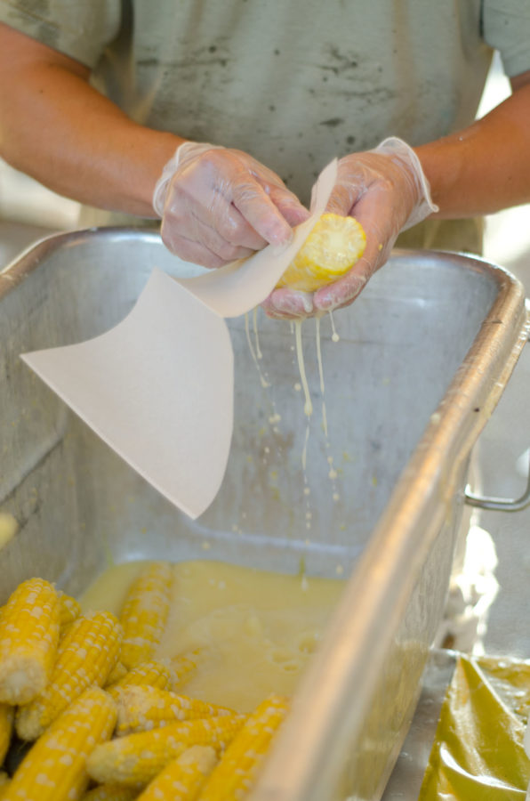 Chong Jiang The Daily IlliniA volunteer butters and wraps up freshly cooked corn on the cob at the Urbana Sweetcorn Festival on Saturday, Aug 27, 2011.