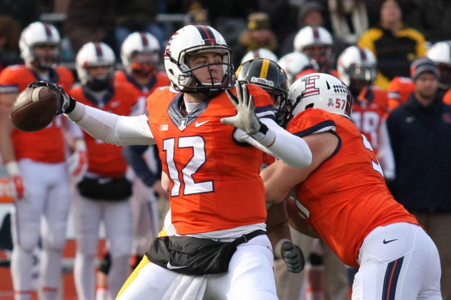 Illinois Wes Lunt (12) looks for an open pass during the game against Iowa at Memorial Stadium on Saturday, Nov. 15, 2014. Illinois lost 30-14.