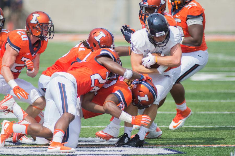 The+Illinois+defense+wraps+up+Kent+State+wide%C2%A0receiver+Connor+Arlia+during+their+season-opener+at+Memorial+Stadium+on+Saturday%2C+September+5.+Illinois+defeated+Kent+State+52-3.