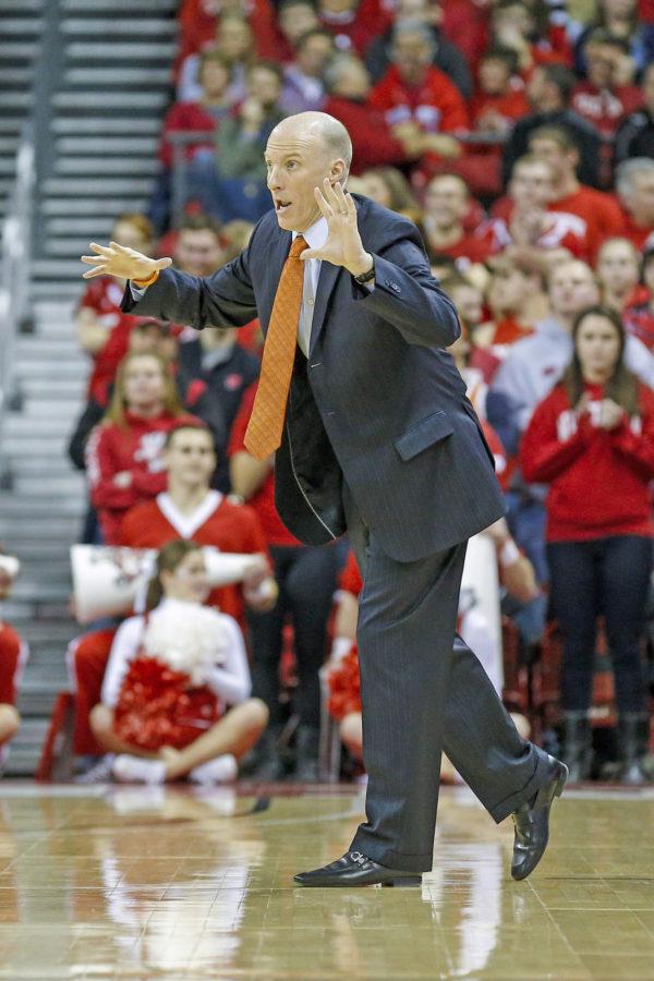 Illinois head coach John Groce makes a call to the team during the game against Wisconsin at the Kohl Center in Madison, Wisc. on Wednesday, Jan. 8, 2014. The Illini lost, 95-70.
