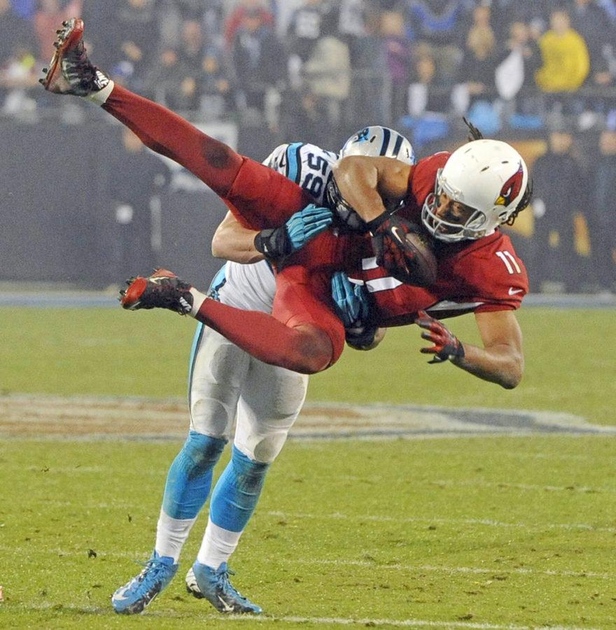 Arizona Cardinals wide receiver Larry Fitzgerald (11) is upended by Carolina Panthers linebacker Luke Kuechly (59) in the second half in NFC Wild Card playoff action at Bank of America Stadium in Charlotte, N.C., on Saturday, Jan. 3, 2015. The Panthers won, 27-16. (David T. Foster, III/Charlotte Observer/TNS)