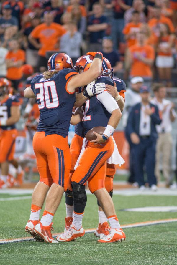 Wes Lunt (12), Jim Nudera (30), and another player celebrate after a successful play in Illinois game vs. Middle Tennessee.